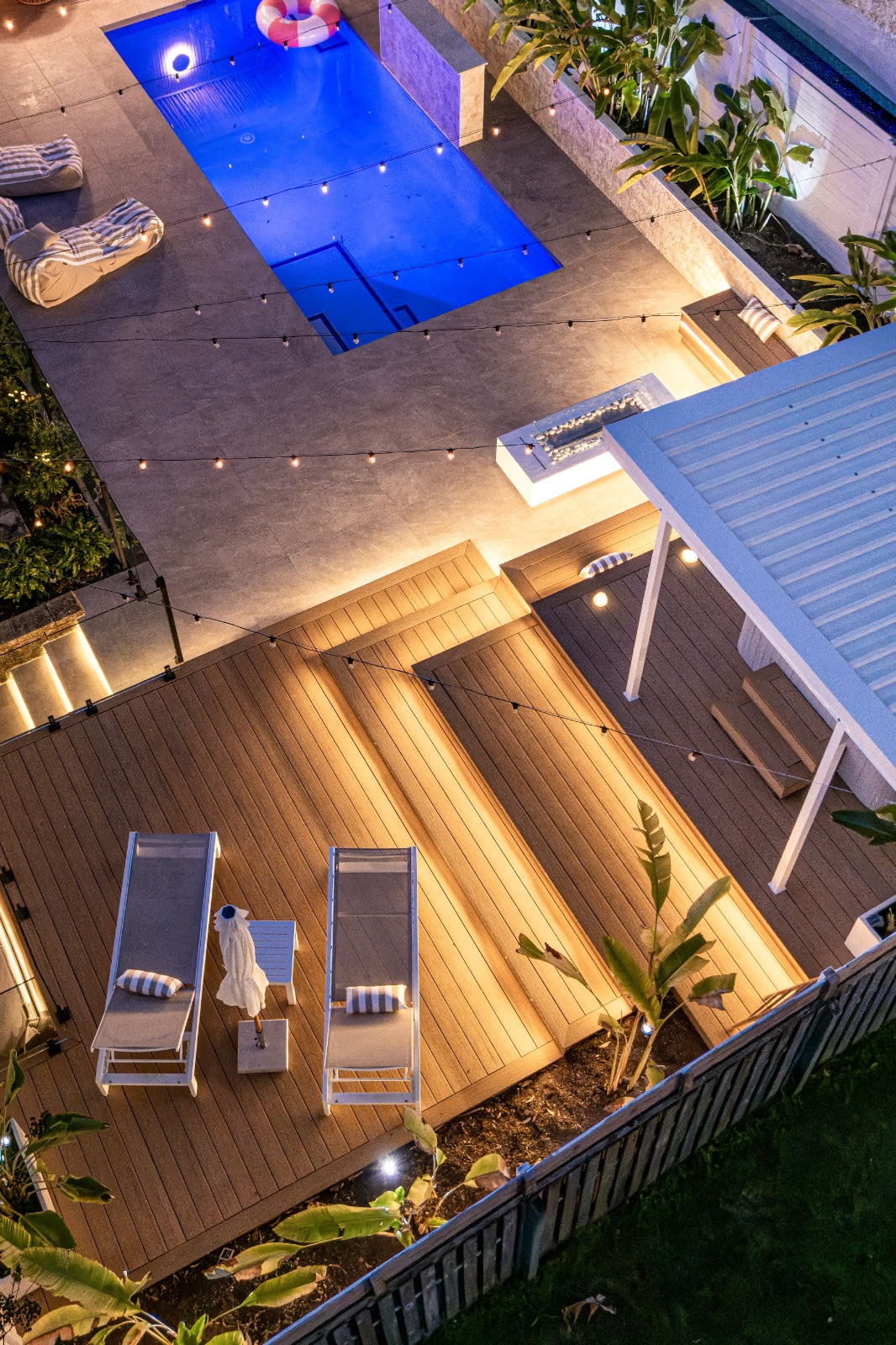 Pool and multi-level deck lit at night